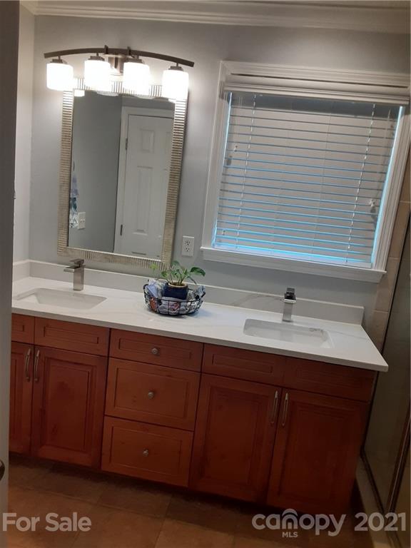 1501 Tyvola Road Charlotte, NC 28210 - Photo 9 of 20 a bathroom with a sink and a mirror
