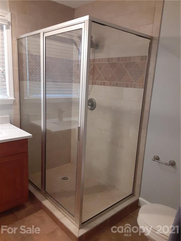 1501 Tyvola Road Charlotte, NC 28210 - Photo 10 of 20 a bathroom with a glass shower door