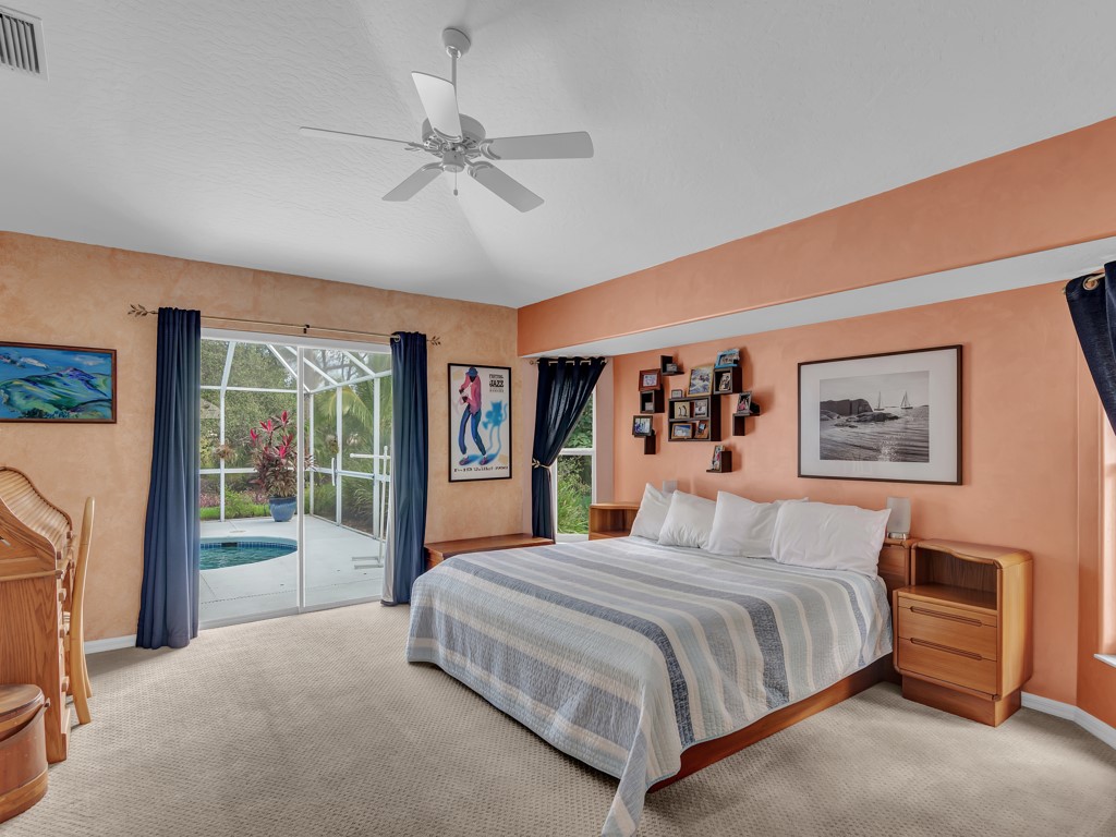 109 Thunderbird Drive Sebastian, FL 32958 - Photo 11 of 27 a bedroom with a large bed and a chandelier