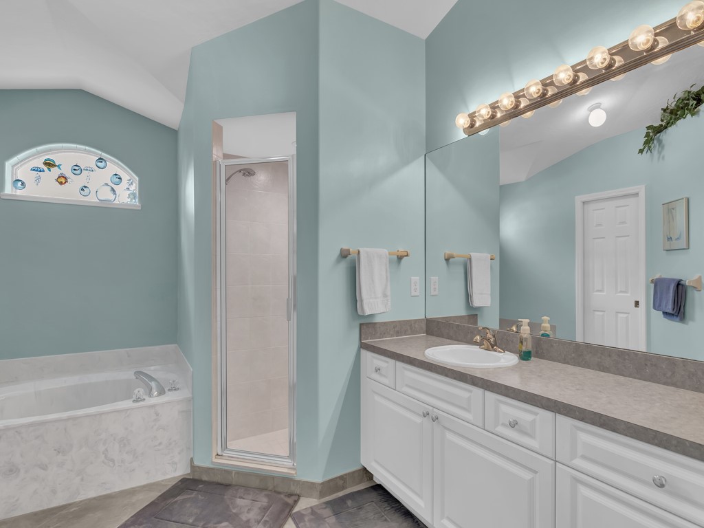 109 Thunderbird Drive Sebastian, FL 32958 - Photo 13 of 27 a bathroom with a granite countertop sink a large mirror and a bathtub