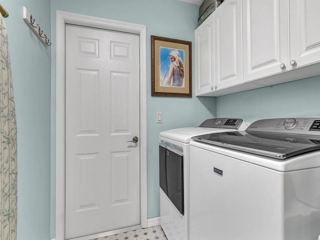 109 Thunderbird Drive Sebastian, FL 32958 - Photo 14 of 27 a utility room with stainless steel appliances granite countertop a stove and a refrigerator