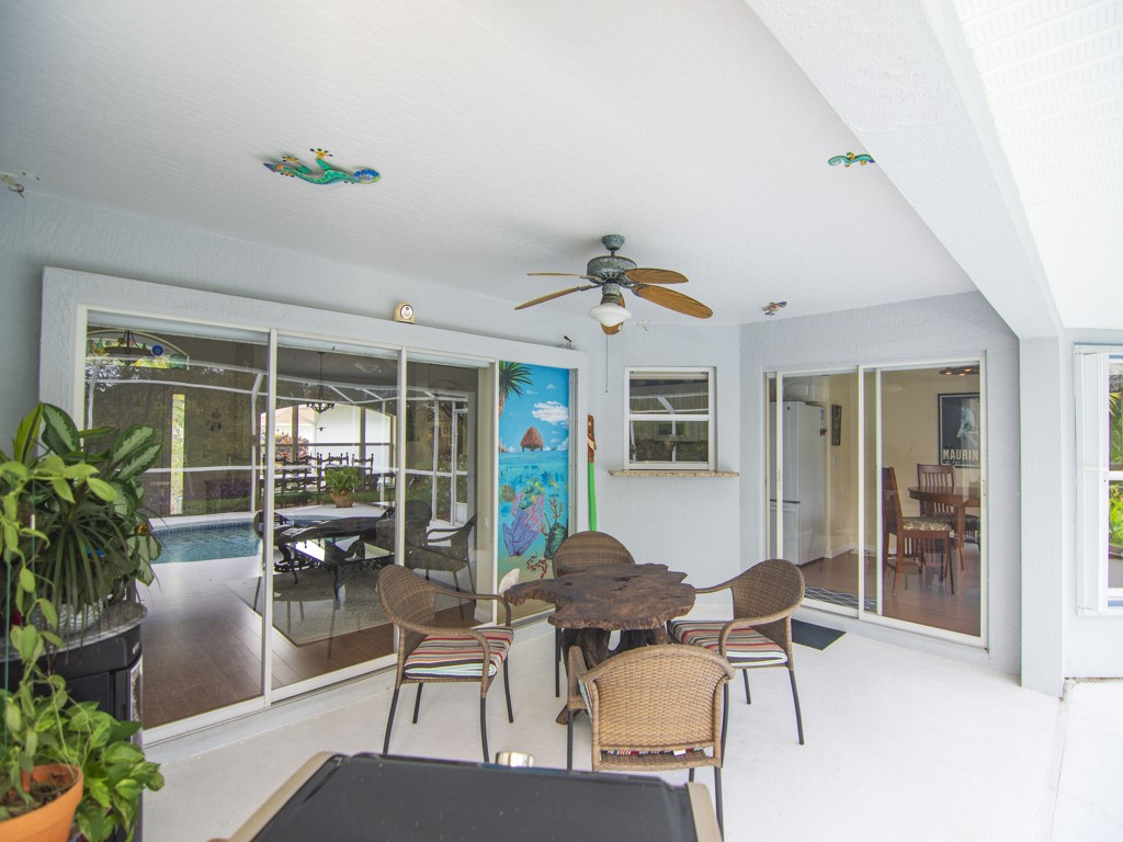 109 Thunderbird Drive Sebastian, FL 32958 - Photo 18 of 27 a outdoor space with patio the couches and a dining table with chairs