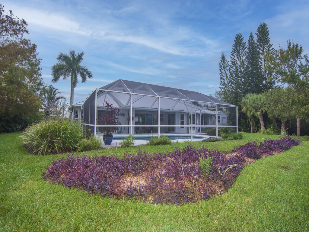 109 Thunderbird Drive Sebastian, FL 32958 - Photo 26 of 27 a view of a house with a big yard and potted plants