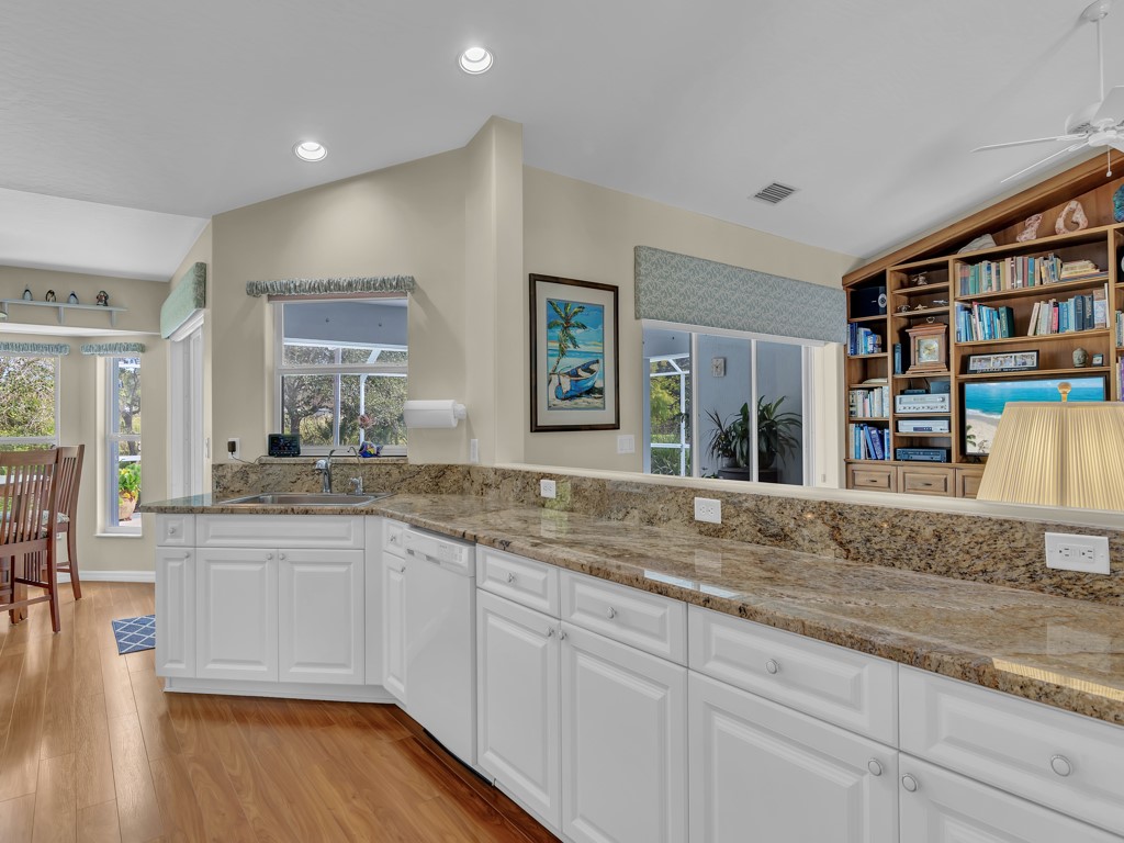 109 Thunderbird Drive Sebastian, FL 32958 - Photo 8 of 27 a open kitchen with granite countertop a sink and dishwasher with wooden floor