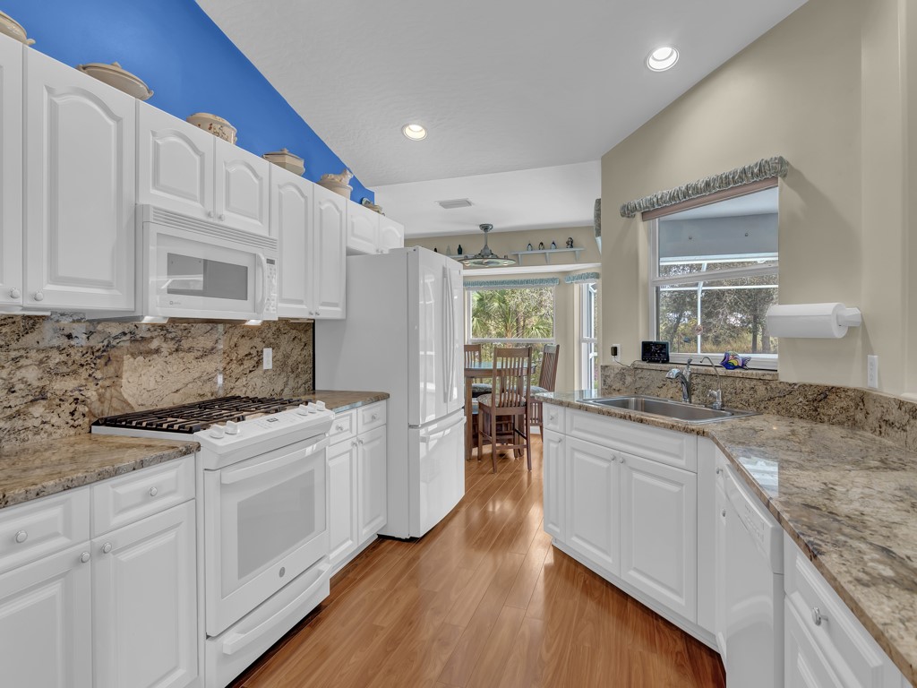 109 Thunderbird Drive Sebastian, FL 32958 - Photo 10 of 27 a kitchen with white cabinets and white appliances