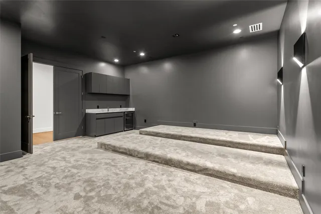 an empty room with windows and ceiling fan