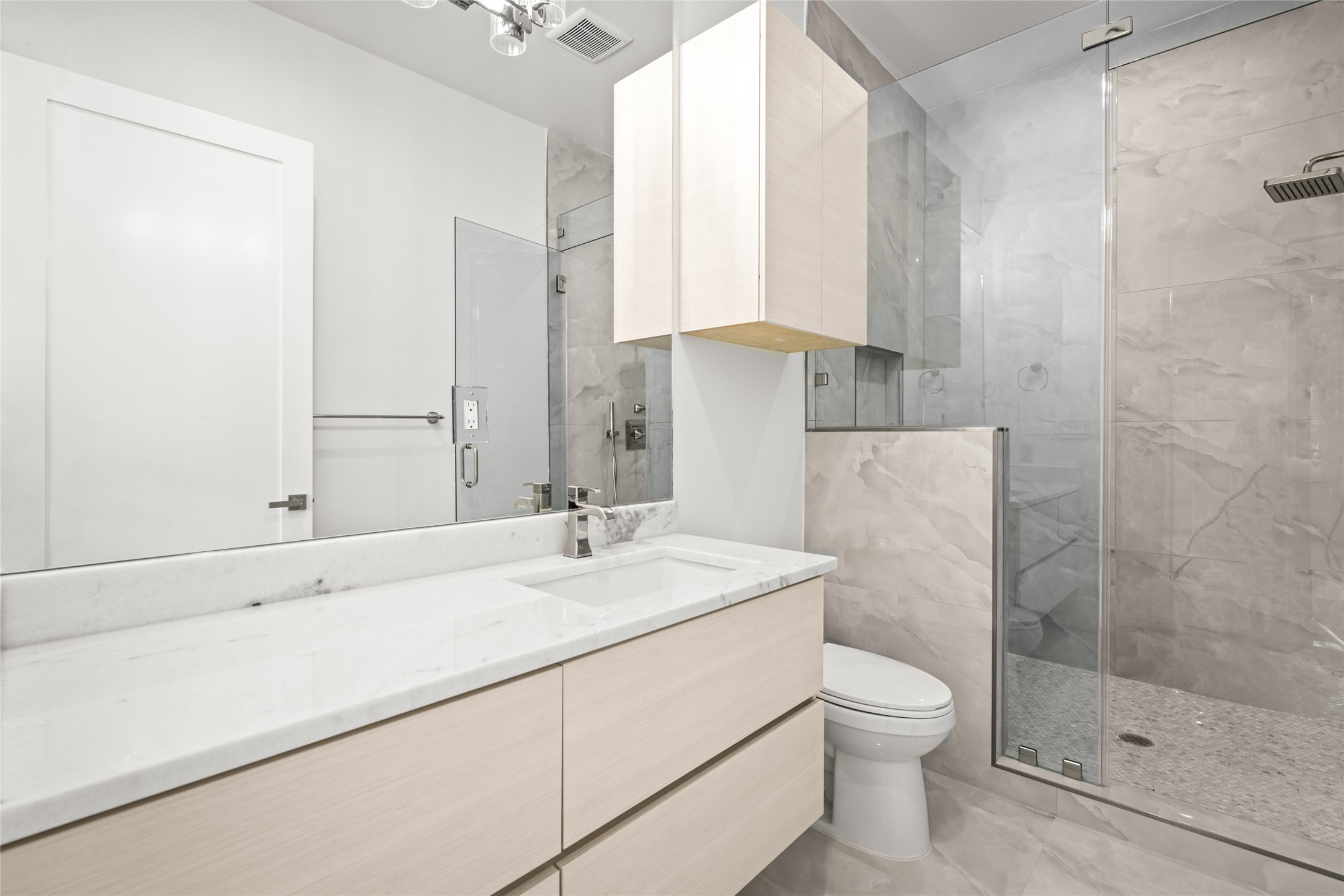 625 Piney Point Road Houston, TX 77024 - Photo 36 of 47 The ensuite bathroom features a modern floating vanity, an oversized walk-in shower with built-in bench, all highlighted w/ polished nickel hardware & fixtures
