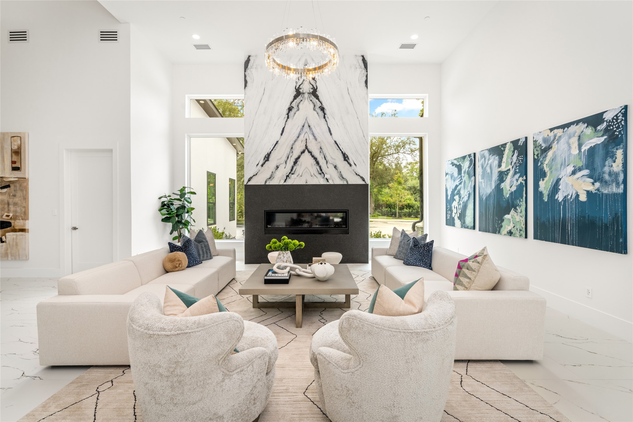 625 Piney Point Road Houston, TX 77024 - Photo 9 of 47 a living room with furniture a fireplace and a chandelier
