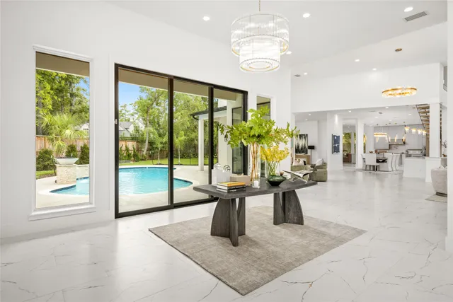 a living room with furniture a fireplace and a chandelier