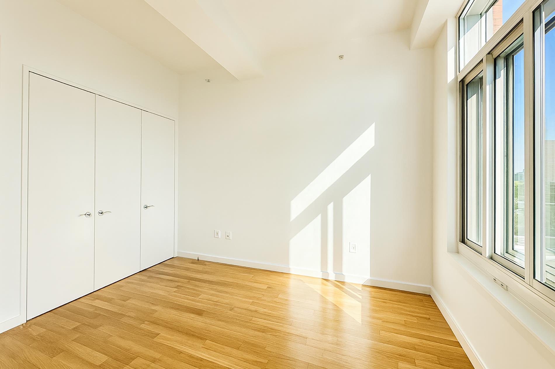 Undisclosed Address Brooklyn, NY 11201 - Photo 15 of 23 a view of empty room with wooden floor and fan