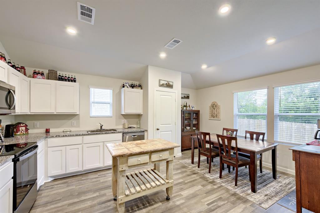 420 Jameson Springtown, TX 76082 - Photo 8 of 29 a kitchen with a table chairs sink and cabinets