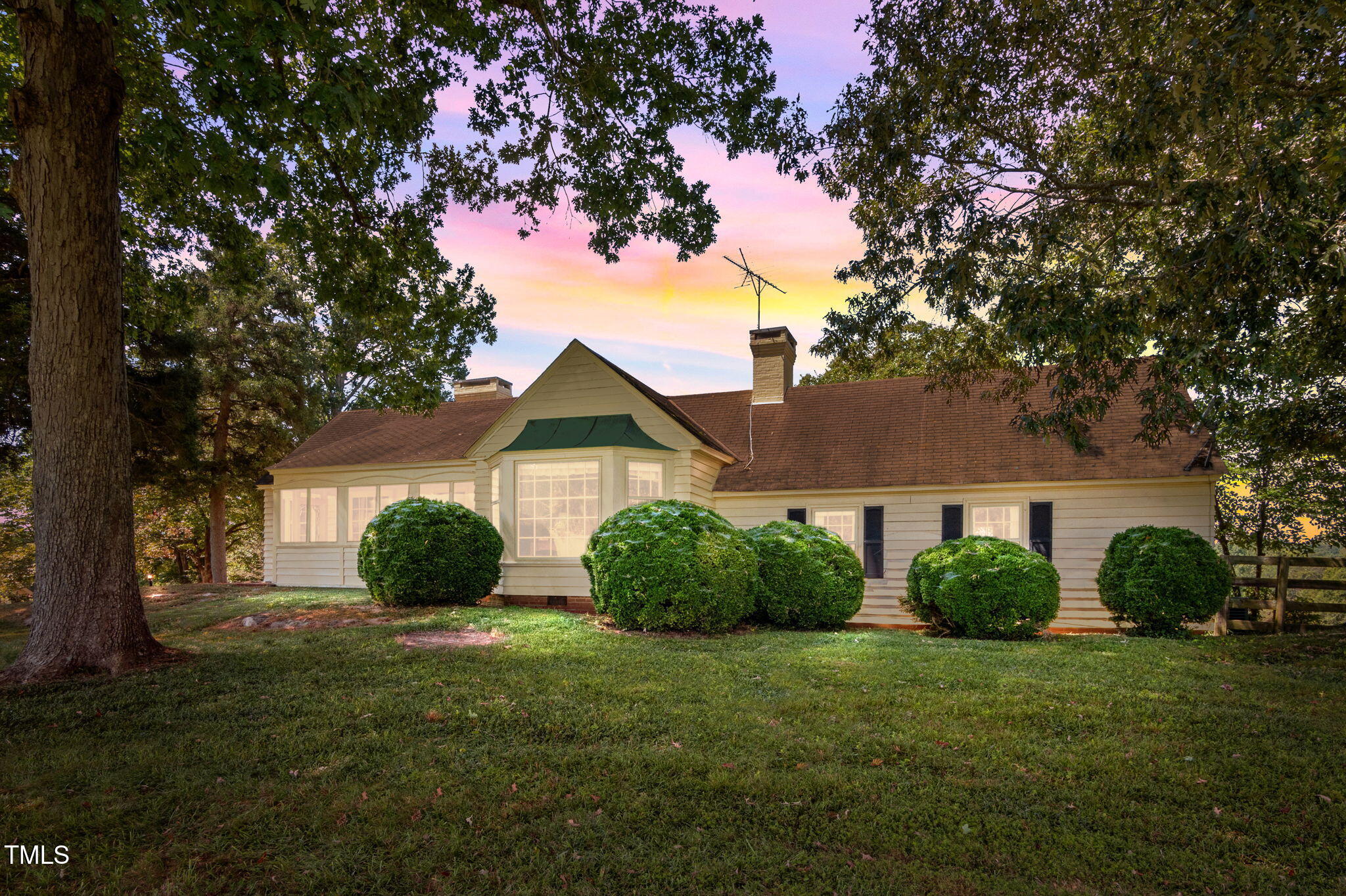 418 Quail Roost Farm Road Rougemont, NC 27572 - Photo 13 of 100 a view of a yard in front of a house with plants and large tree