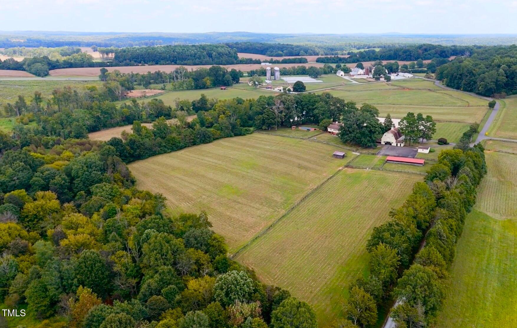 418 Quail Roost Farm Road Rougemont, NC 27572 - Photo 3 of 100 an aerial view of a house with a garden