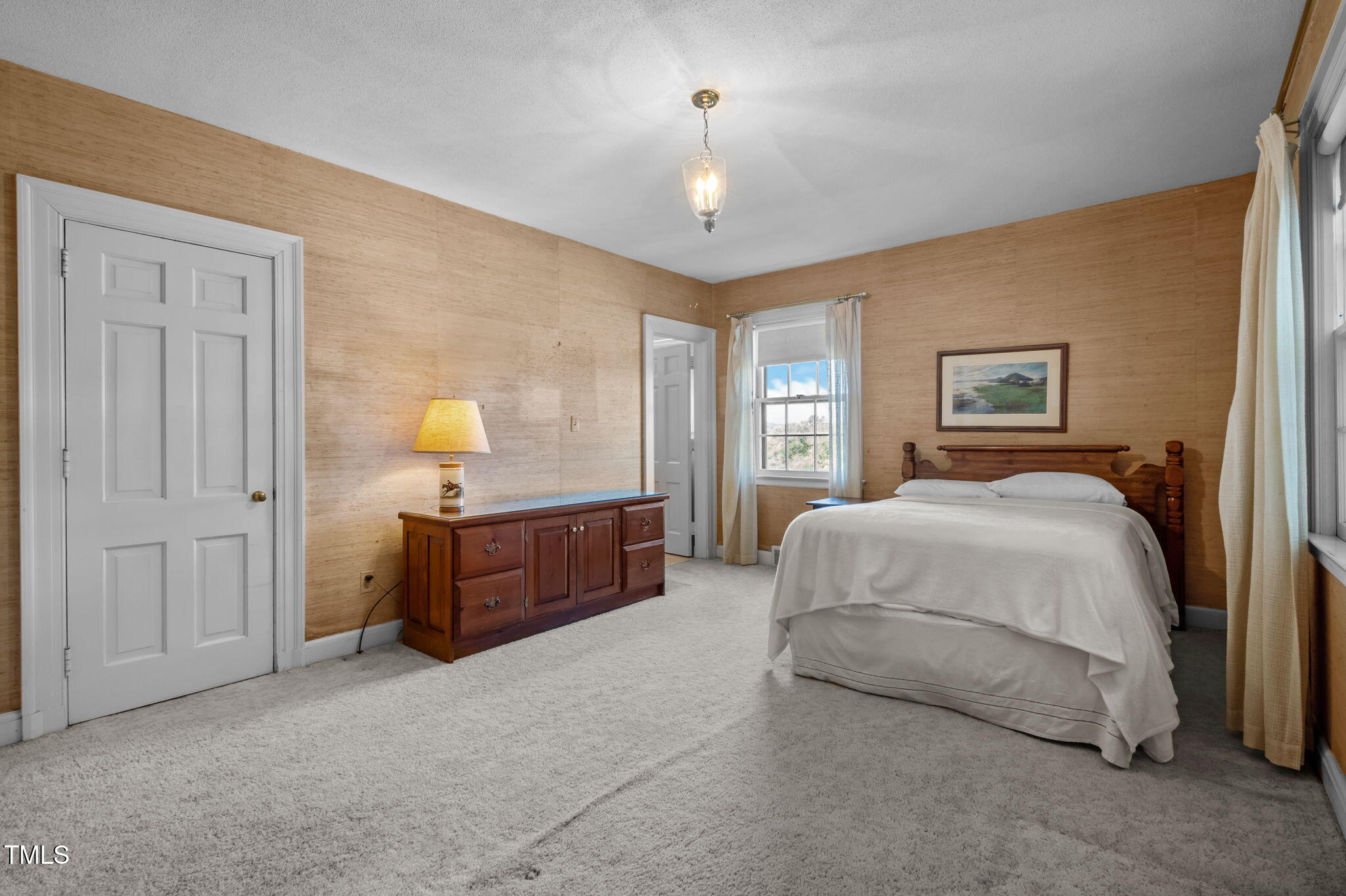 418 Quail Roost Farm Road Rougemont, NC 27572 - Photo 69 of 100 a spacious bedroom with a bed and a chandelier
