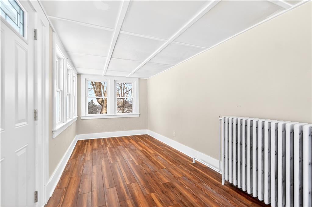 127 Rose Road Mount Pleasant, PA 15666 - Photo 15 of 47 a view of an empty room with a window and wooden floor
