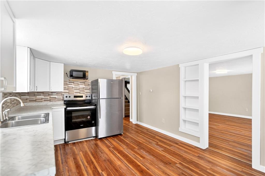 127 Rose Road Mount Pleasant, PA 15666 - Photo 30 of 47 a kitchen with granite countertop a refrigerator and a sink