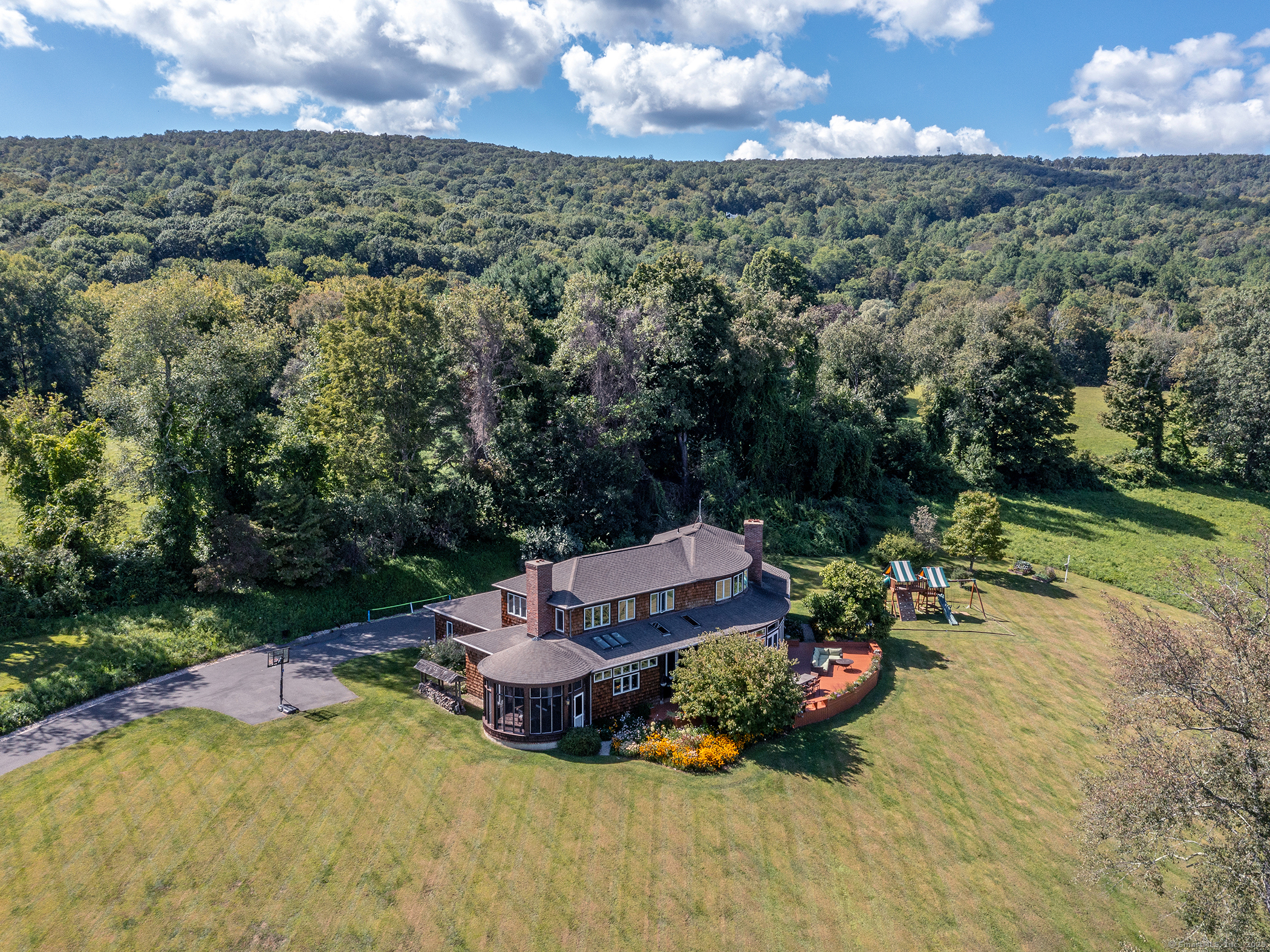 an aerial view of a house with a garden and lake view
