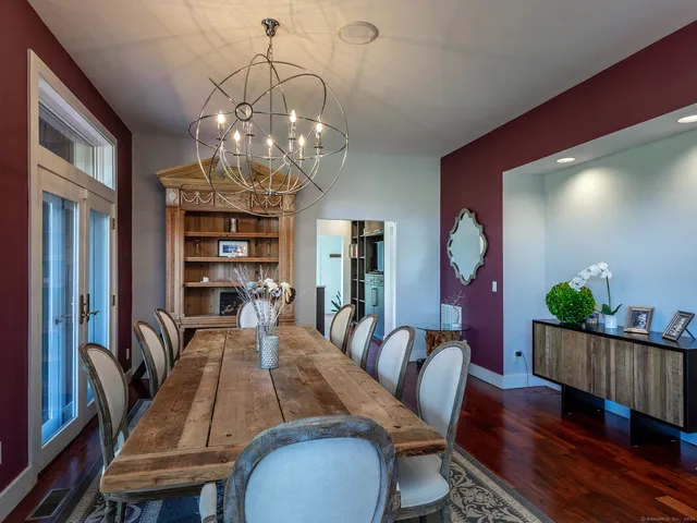 a view of a dining room with furniture wooden floor and chandelier