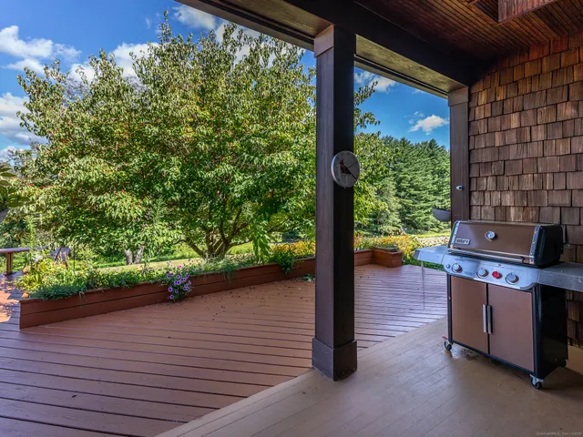 a backyard of a house with a garden and outdoor seating