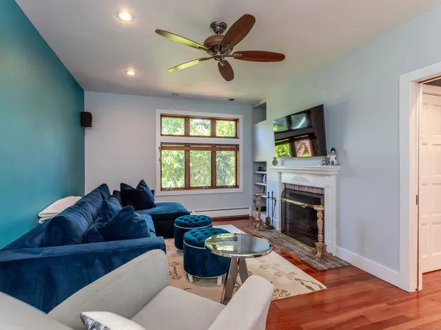 a living room with furniture a window and a fireplace