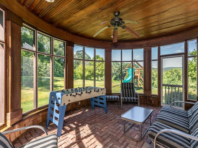 a bedroom with furniture and large windows