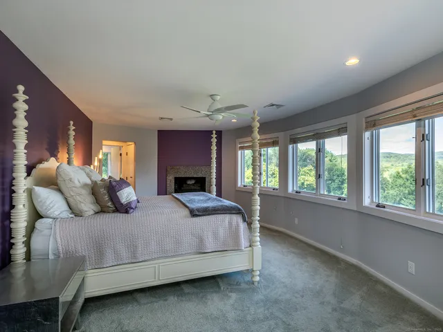 a bedroom with a large bed and a large window