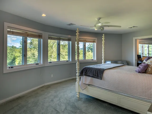 a bedroom with a large bed and a large window