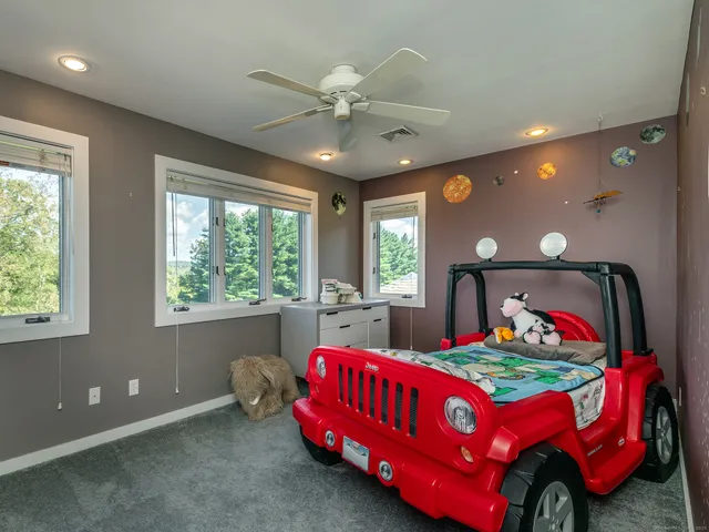 a bedroom with a bed and window