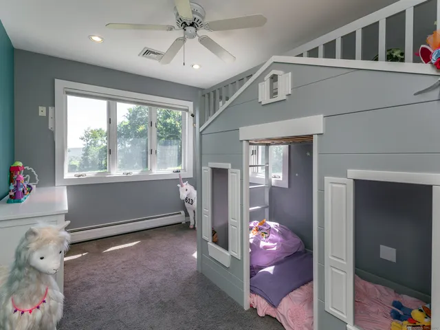 a bedroom with furniture and a large window