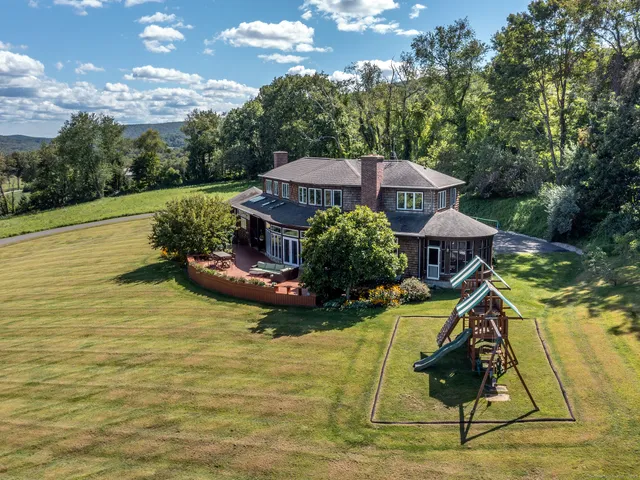 a view of a house with pool and sitting area