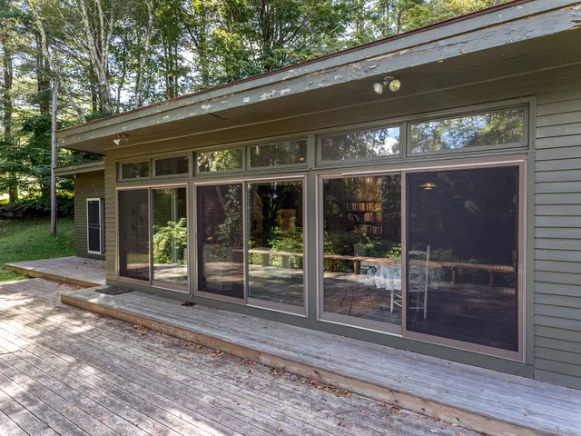 a view of a house with a large window and wooden floor