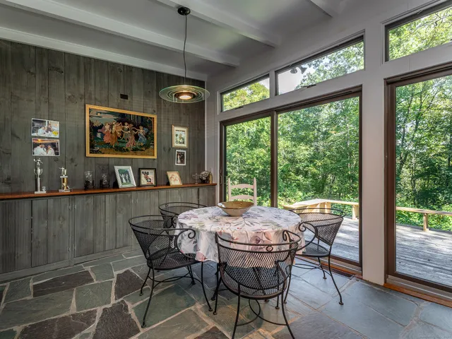 a view of a dining room with furniture large window and outside view