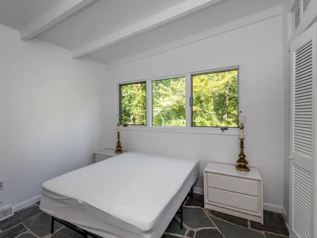 a room with a bed and a window