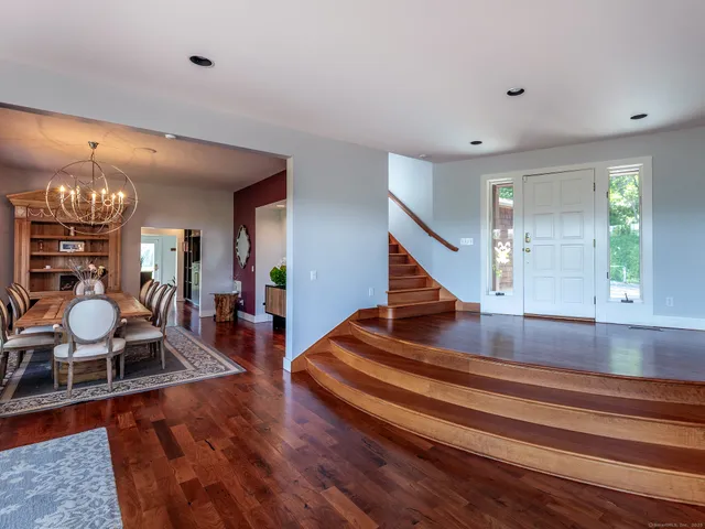 a view of entryway and hall with wooden floor