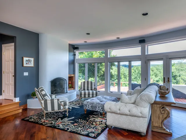 a living room with furniture and large windows