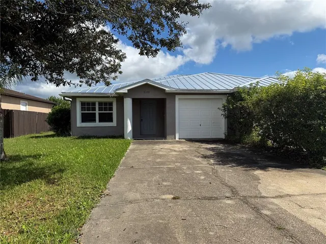 a front view of a house with a garden and yard