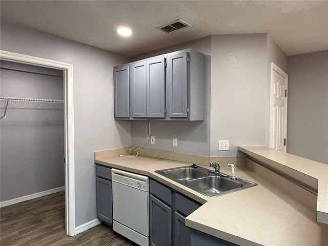 a kitchen that has a sink and a stove top oven