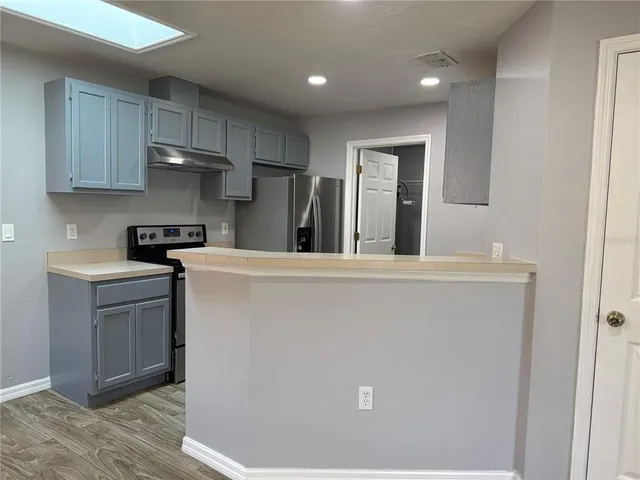 a kitchen with stainless steel appliances granite countertop a refrigerator sink and cabinets