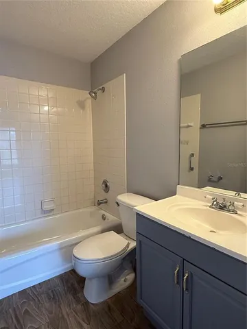 a bathroom with a sink a toilet and bathtub