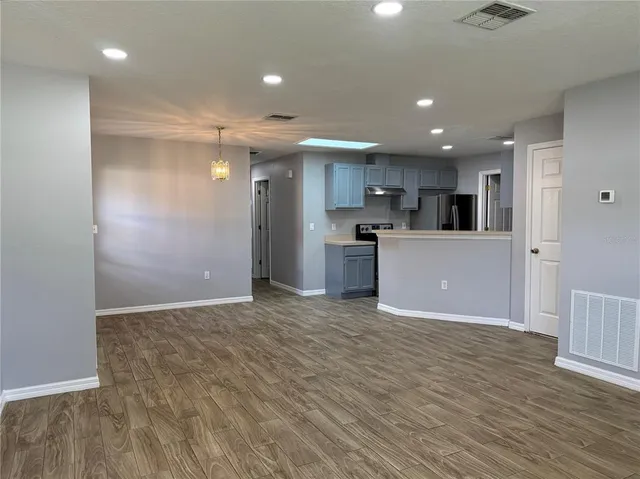 a view of a kitchen with a sink and a refrigerator