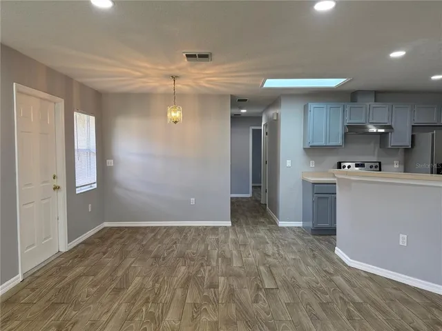 a view of a kitchen with a sink and a refrigerator