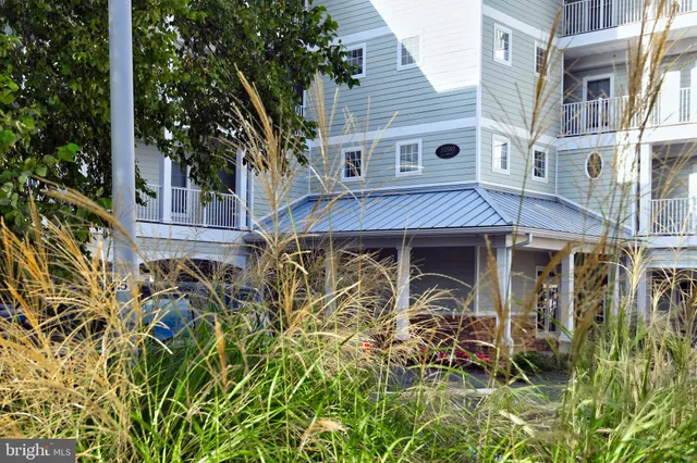 a view of a house with wooden fence