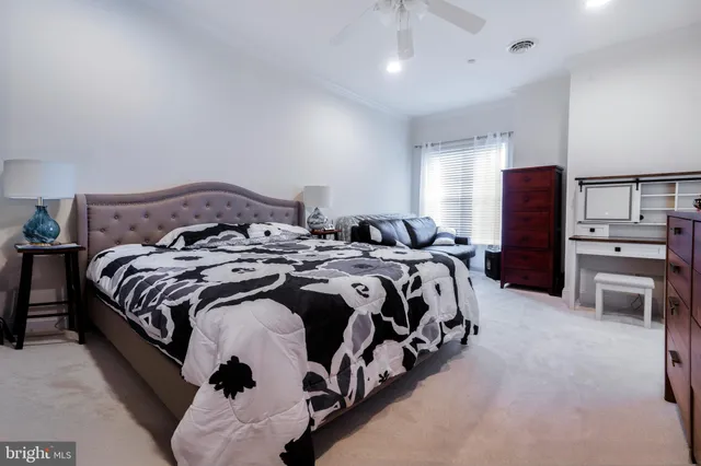 a bedroom with a bed and a dresser