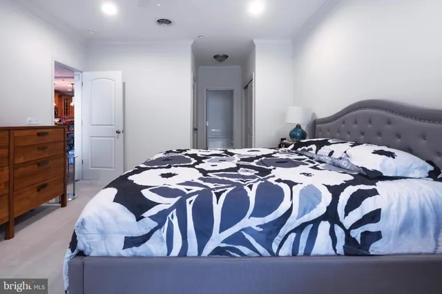 a bedroom with a bed and a dresser