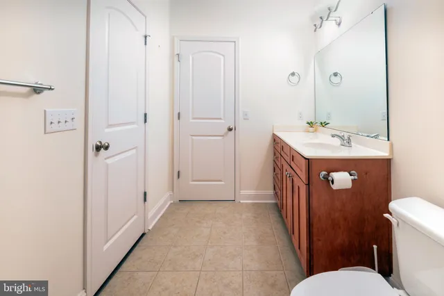 a bathroom with a sink a toilet and a mirror