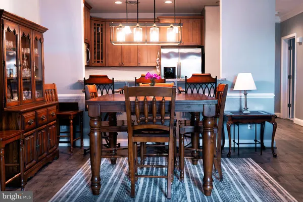 a living room with furniture a rug and kitchen view