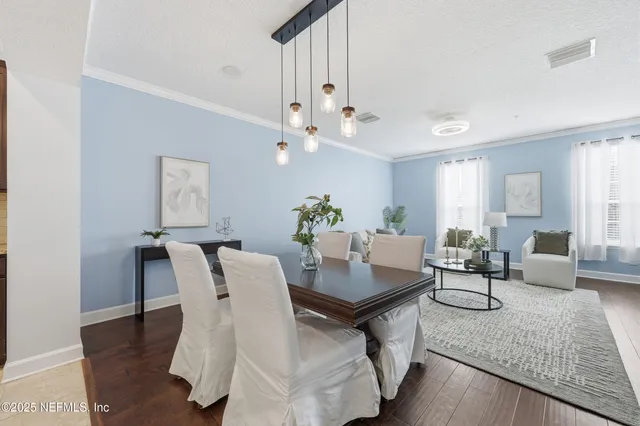 a dining room with furniture and wooden floor