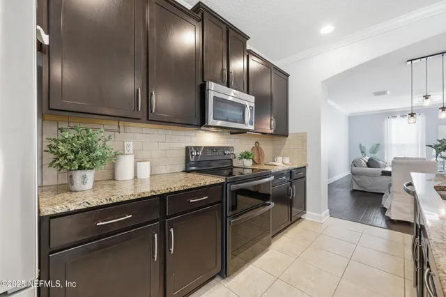 a large kitchen with kitchen island granite countertop a large counter top and appliances