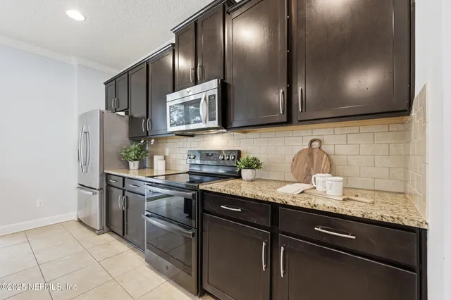 a kitchen with a sink and a potted plant