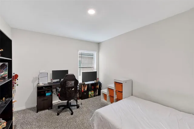 a bedroom with a workspace